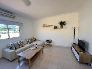 a living room with a couch and a coffee table at Casa Oreo in Tarajalejo