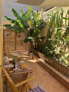 a patio with a table and a bunch of plants at Casa Oreo in Tarajalejo +4 photos