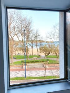 a view of a park from a window at Apartamento con vistas a la playa in Santander