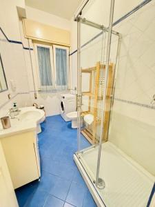 ein Badezimmer mit Dusche, Waschbecken und Toilette in der Unterkunft Viareggio on the Beach - Apartment in Viareggio + 48 Fotos