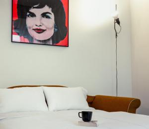 a picture of a woman on the wall above a bed at Luxury Loft near Duomo and Garage in Milan