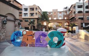 a sign that says ego in front of a building at Harbour Junior suites in Cabo San Lucas