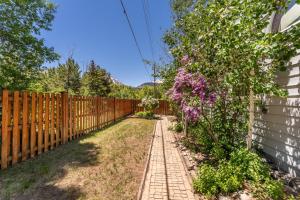 a fence next to a garden with purple flowers at 1101 Mesa Drive: 2 in Silverthorne