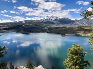 a view of a lake with mountains in the background at 1101 Mesa Drive: 2 in Silverthorne