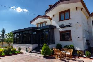 a building with a table and chairs in front of it at Cappadocia Villa Comfort in Nevşehir +27 photos