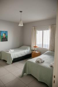 a bedroom with two beds and a window at Ramas House in San Rafael