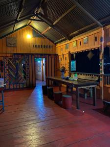 a large room with a wooden table in a building at Hostal Búho Amazonas tours in Leticia