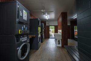a laundry room with a washer and dryer at Daintree Beach Resort in Wonga