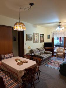 a living room with a table and a couch at Apto 104 in Gramado