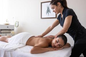 a woman getting a massage from a therapist at InterContinental Genève by IHG in Geneva