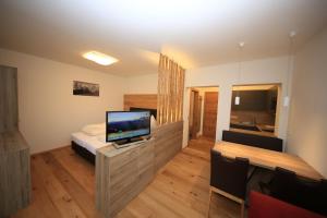 a bedroom with a bed and a television on a counter at Chalet Findeisen in Ramsau am Dachstein