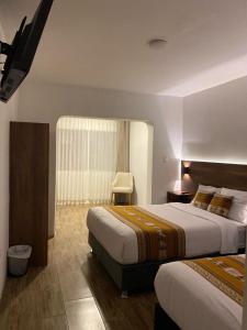 Postel nebo postele na pokoji v ubytování Hotel Rumi