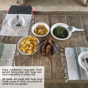 a table with three bowls of food on it at Banlue handicraf center and home stay in Nam Bak