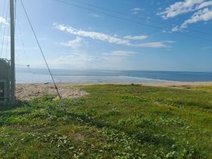 a view of a beach with the ocean in the background at Home at the beach in Ingham in Allingham +4 photos