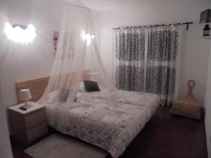 a bedroom with a bed with a mosquito net at Lagos Charming Villas in Lagos