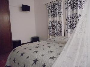 a bedroom with a bed with stars on it at Lagos Charming Villas in Lagos