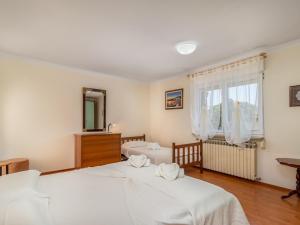 a bedroom with two beds and a mirror at Family friendly house with a swimming pool Jadranovo, Crikvenica - 22273 in Jadranovo