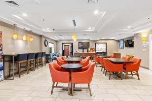 a dining room with tables and orange chairs at Holiday Inn Express & Suites Wytheville by IHG in Wytheville