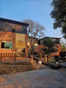 a brick building with a mural on the side of it at Pousada Gendra's in Imbituba