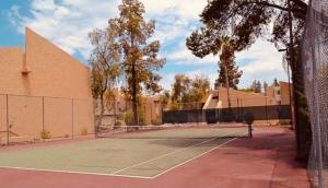 a tennis court with a net on top of it at Rustic Farmhouse Old Town Condo W Patio & Pool in Scottsdale