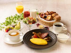 a table with a plate of breakfast food and drinks at Hotel Granvia Kyoto in Kyoto