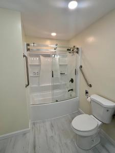 a white bathroom with a toilet and a shower at Luxury Home near Notre Dame with Arcade Room in South Bend