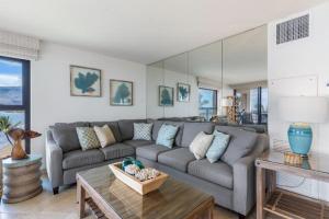 a living room with a couch and a table at Sugar Beach Resort, #535 in Kihei