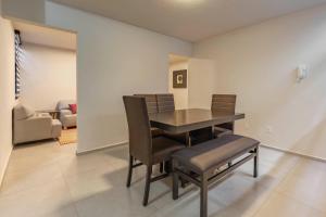 a dining room with a table and chairs at Lofts By Verticca in Santa Cruz Tecamac