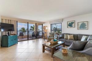 a living room with a couch and a tv at Sugar Beach Resort, #535 in Kihei