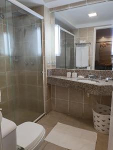 a bathroom with a shower and a toilet and a sink at Flat Beira Mar Meireles in Fortaleza +9 photos