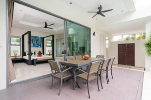 een eetkamer met een tafel en stoelen bij Relax & Enjoy Stay! Elegant 3BR Pool Villa Talosy in Rawai Beach