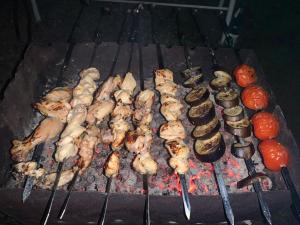 a bunch of meat and vegetables on a grill at hotel pillows in Martvili
