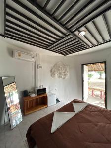 a bedroom with a large bed and a large window at Ban Tai Bay Bungalows in Ban Tai
