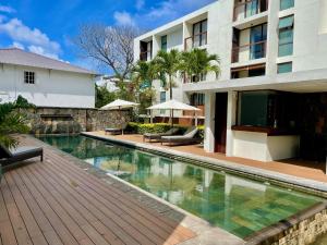 a swimming pool in front of a building at Belle Haven GF 1bedroom flat in Mont Choisy
