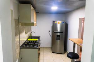 a kitchen with a refrigerator and a stove in it at Coliving La Rebeca Pereira in Pereira +32 photos