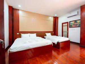 Postel nebo postele na pokoji v ubytování Vientiane Ruby Villa Hotel
