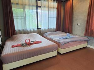 two beds with hearts on them in a bedroom at Preme House Boutique in San Sai +54 photos