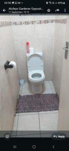 a bathroom with a white toilet in a stall at Lubo house in Pinetown