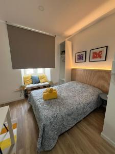 a bedroom with a bed and a large screen at Estrela da Almada Mascarenhas in Almada