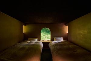 Ein Bett oder Betten in einem Zimmer der Unterkunft ist - Aokinodaira Field
