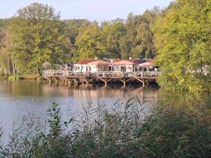 a house on a bridge over a body of water at Vakantiehuis chaletje in Lanaken
