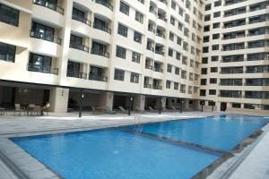 a large swimming pool in front of a building at Golden Seagulls Hotel in Manila