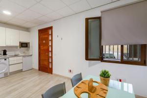 a dining room with a table and a kitchen at Eva García Naranjo in Las Palmas de Gran Canaria