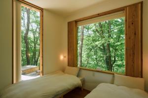 Ein Bett oder Betten in einem Zimmer der Unterkunft ist - Aokinodaira Field
