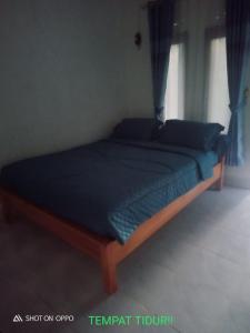 Ένα ή περισσότερα κρεβάτια σε δωμάτιο στο Homestay Saptia Dewi
