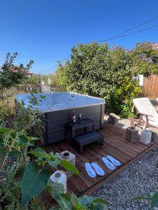 a hot tub sitting on a wooden deck in a backyard at Villa Kallisti - private villa with hot tub, large garden, close to the beach in Ayía Varvára