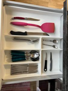 a drawer full of utensils in a cabinet at Charmante Wohnung im Herzen von Graz in Graz