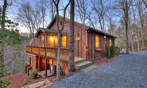 a small cabin in the woods with the lights on at American Dream Americana decor close to downtown Blue Ridge in Blue Ridge
