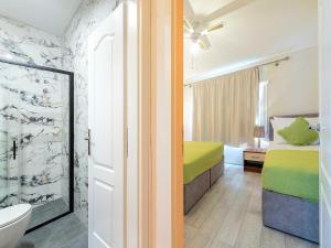 a bedroom with a bed and a bathroom at Villa Dubelj Dubrovnik - One-Bedroom Apartment - 2 in Komolac