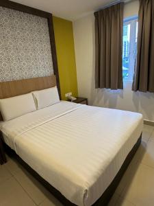 Postel nebo postele na pokoji v ubytování South of The Clouds HOTEL KL Sentral 吉隆坡彩云之南酒店-中央车站店